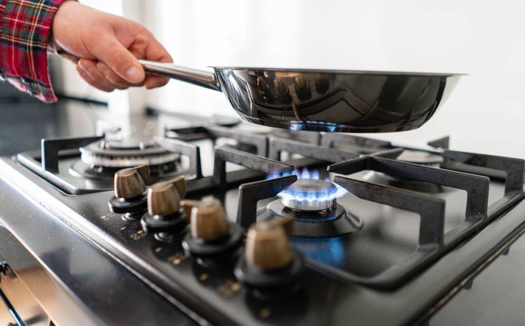 Man cooks in a frying pan